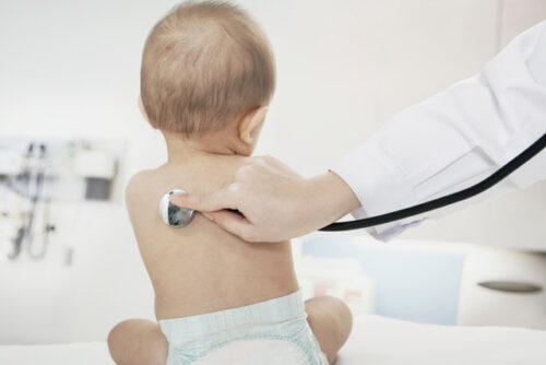 Doctor checking heartbeat with a stethoscope