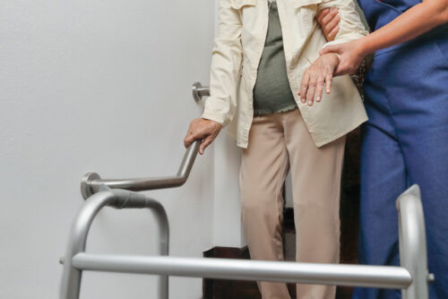 Elderly woman with caregiver