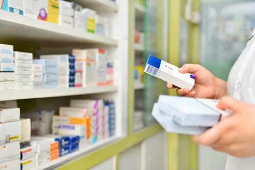 Pharmacist holding medicine box