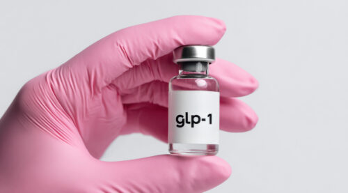 Healthcare professional holding a GLP-1 medication vial
