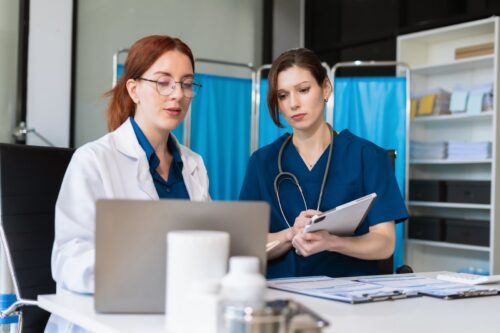 Medical team reviewing a patient's chart and medication history in a hospital setting